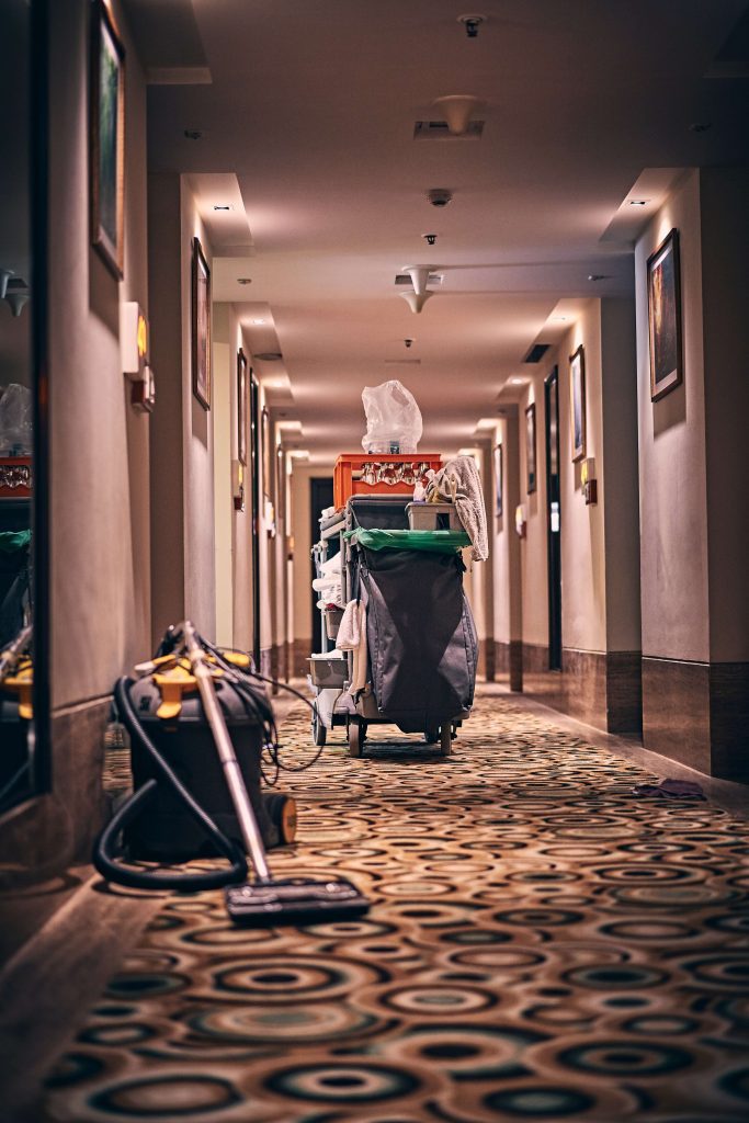 a vacuum on a carpeted hotel floor