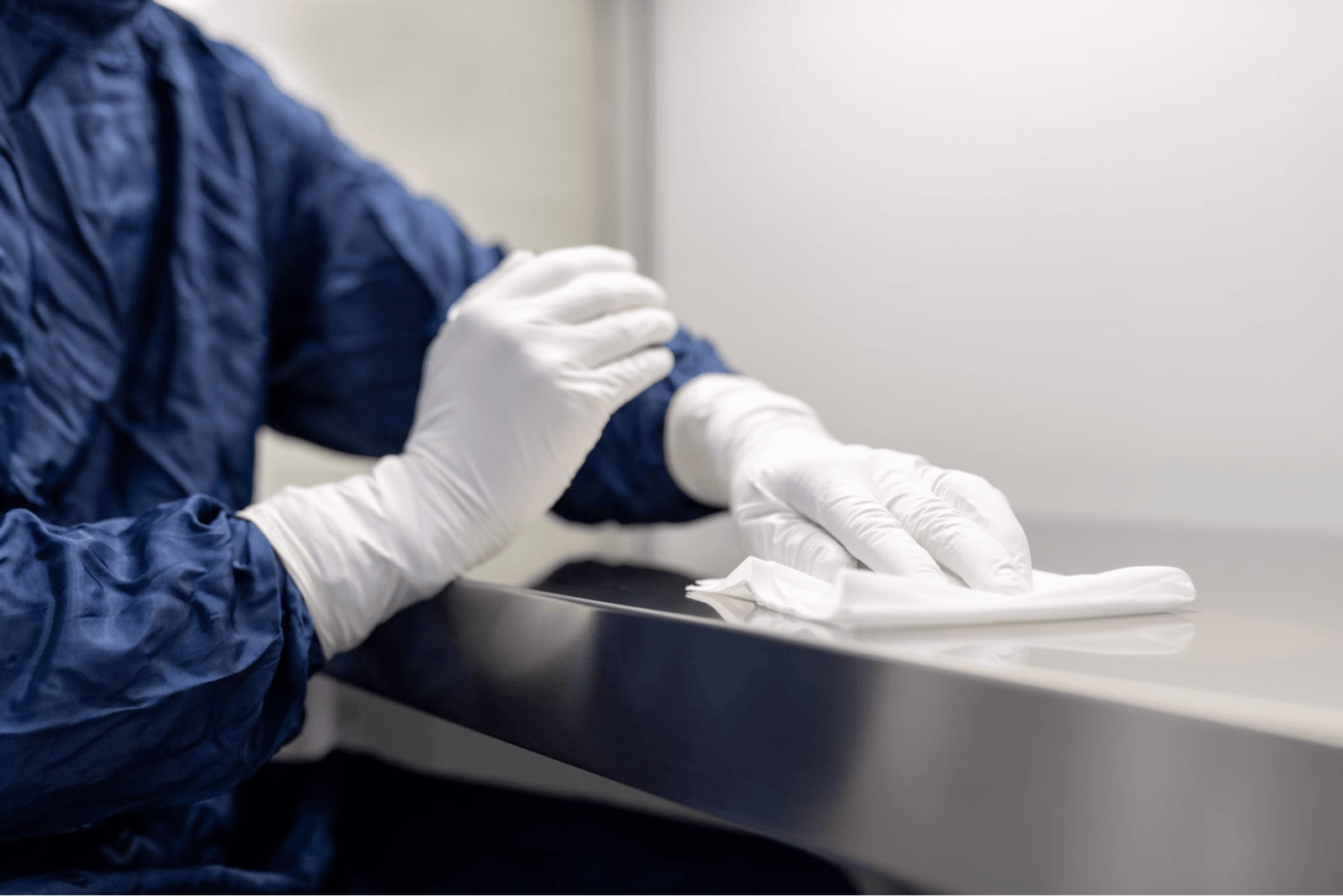 A professional cleaner disinfects a countertop