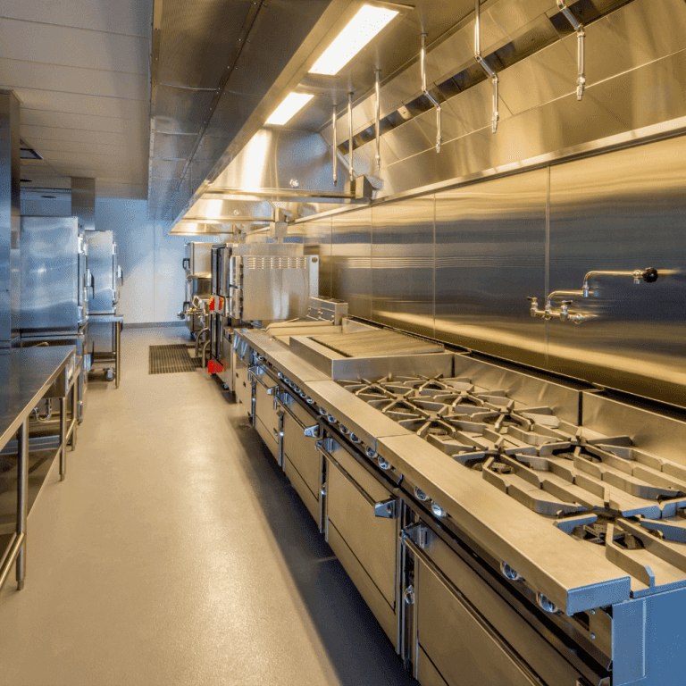 An immaculately clean commercial range, hood, and related equipment