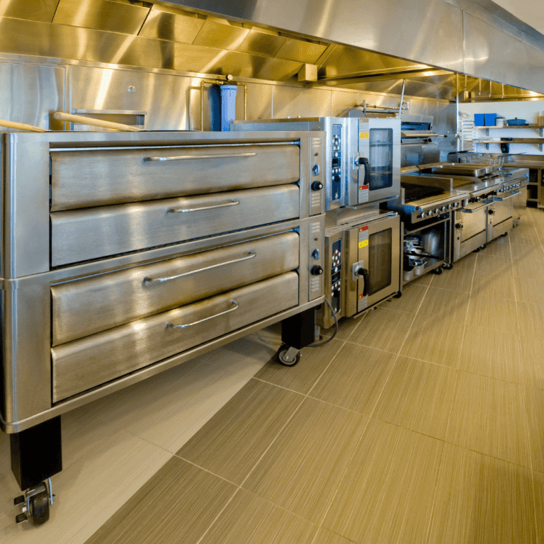Clean commercial stoves, ovens, and other equipment in a professional kitchen